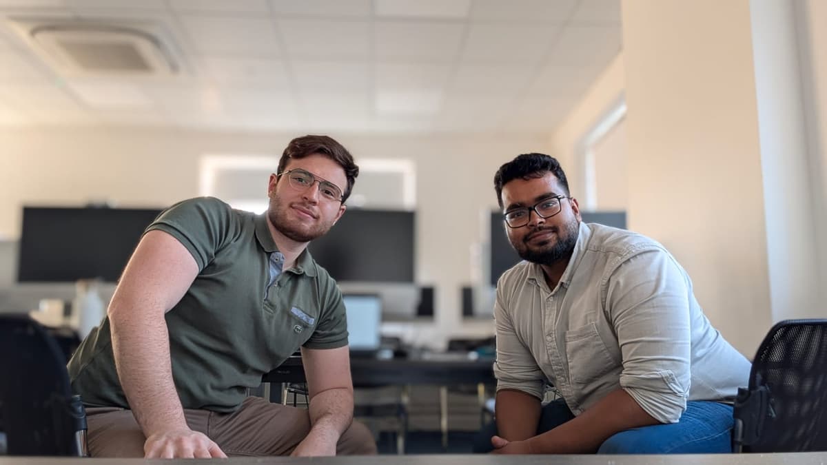 Founders working on AI Embed project at computers